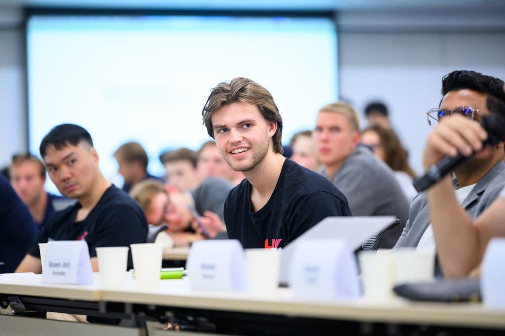 Finley Sieben seated at a long table during the Hong Kong AI Summit