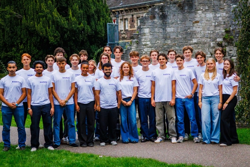 The MAIN team standing together outdoors in matching shirts